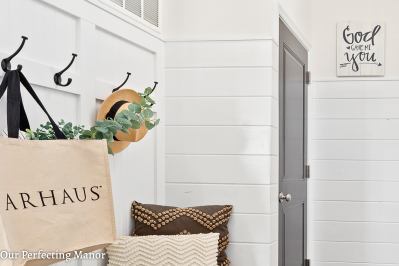 A fixer upper style mudroom with shiplap.