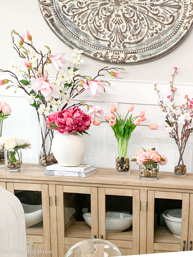 These are beautiful spring florals arranged in glass cylinder vases.