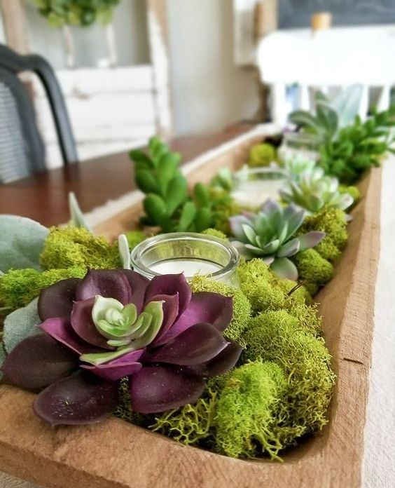 https://www.ourperfectingmanor.com/wp-content/uploads/2020/03/a-dough-bowl-centerpiece-with-moss-succulents-and-candles-in-a-glass-candle-holder-is-a-trendy-idea.jpg